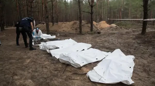 Ukrainians search grave site
