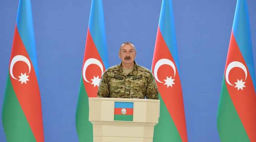 President Ilham Aliyev speaks in front of service members in Shusha