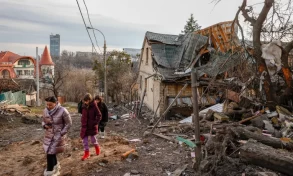 People walk through a damaged neighbourhood after the Russian missile attacks in the Solomyansk district of Kyiv, Ukraine, today.