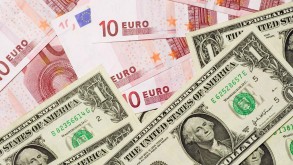 Dollar marches higher, euro teeters on brink of parity